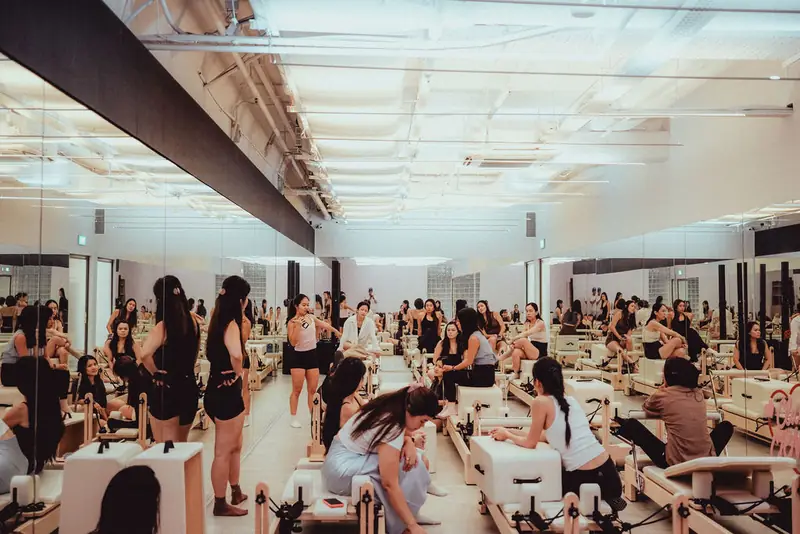 A full reformer pilates room, seen wide